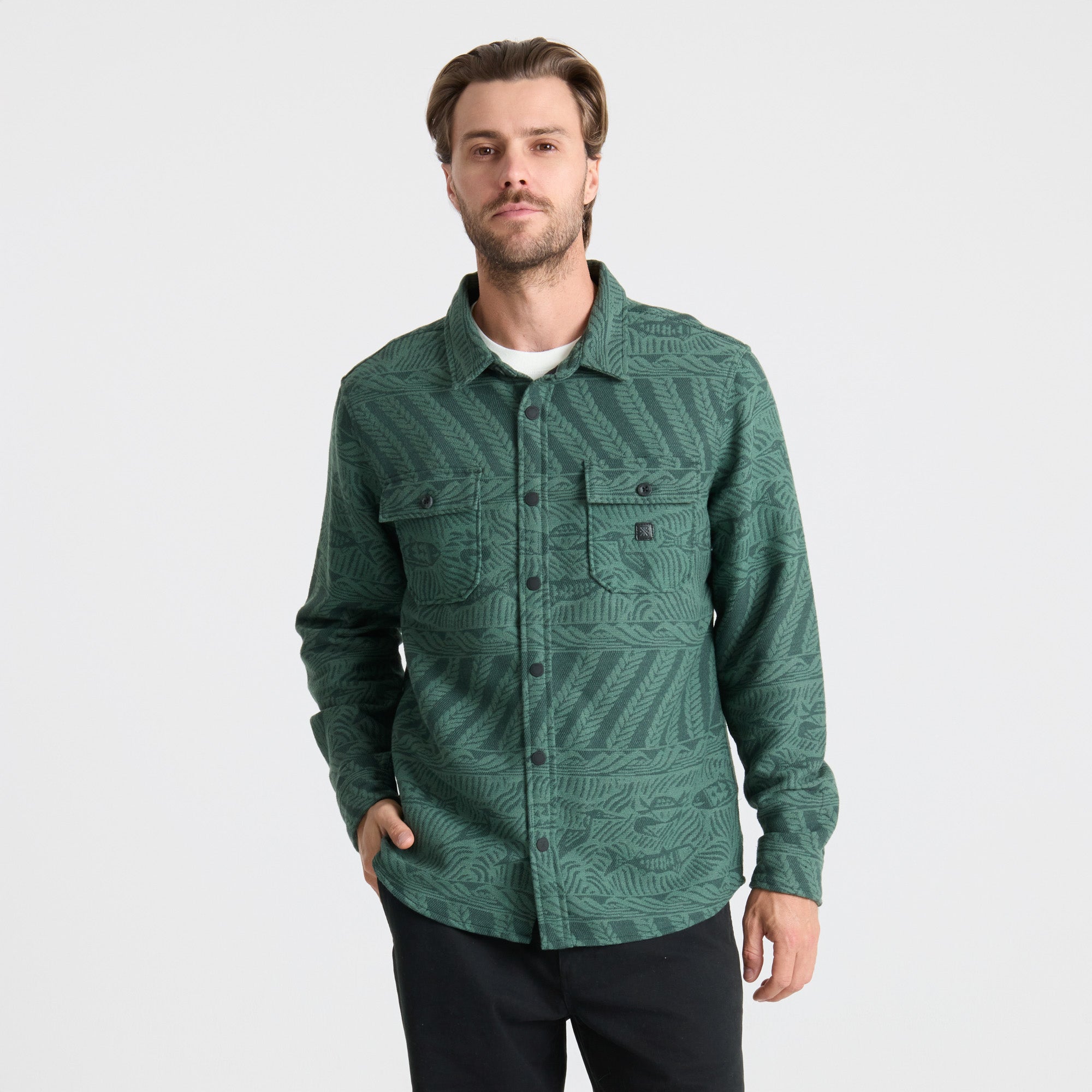 Detail of a rugged Roark adventure shirt featuring durable collar, sturdy buttons, and practical pocket for outdoor activities.