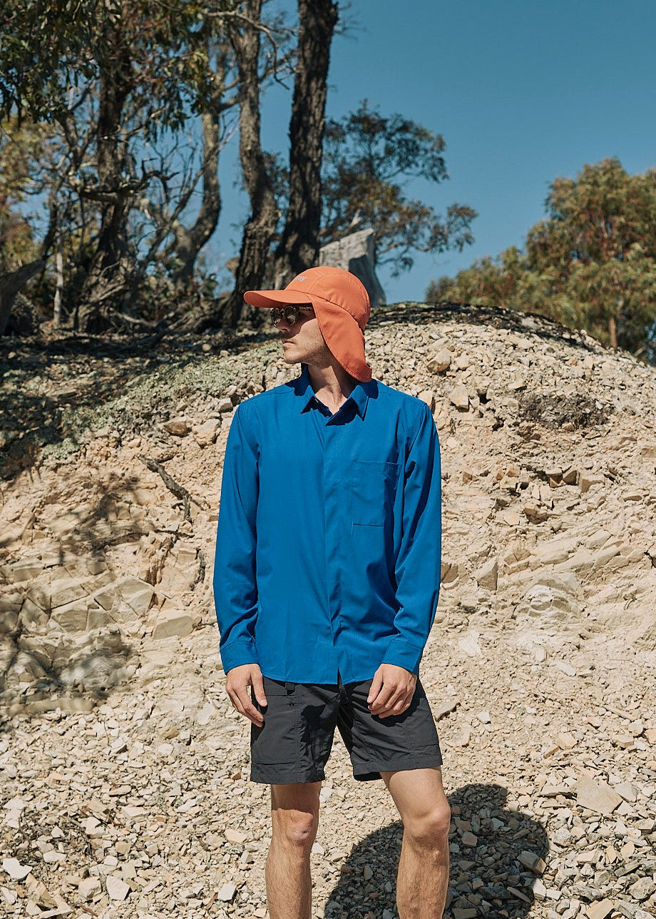 Person wearing an orange UPF50+ sun protection legionnaire hat