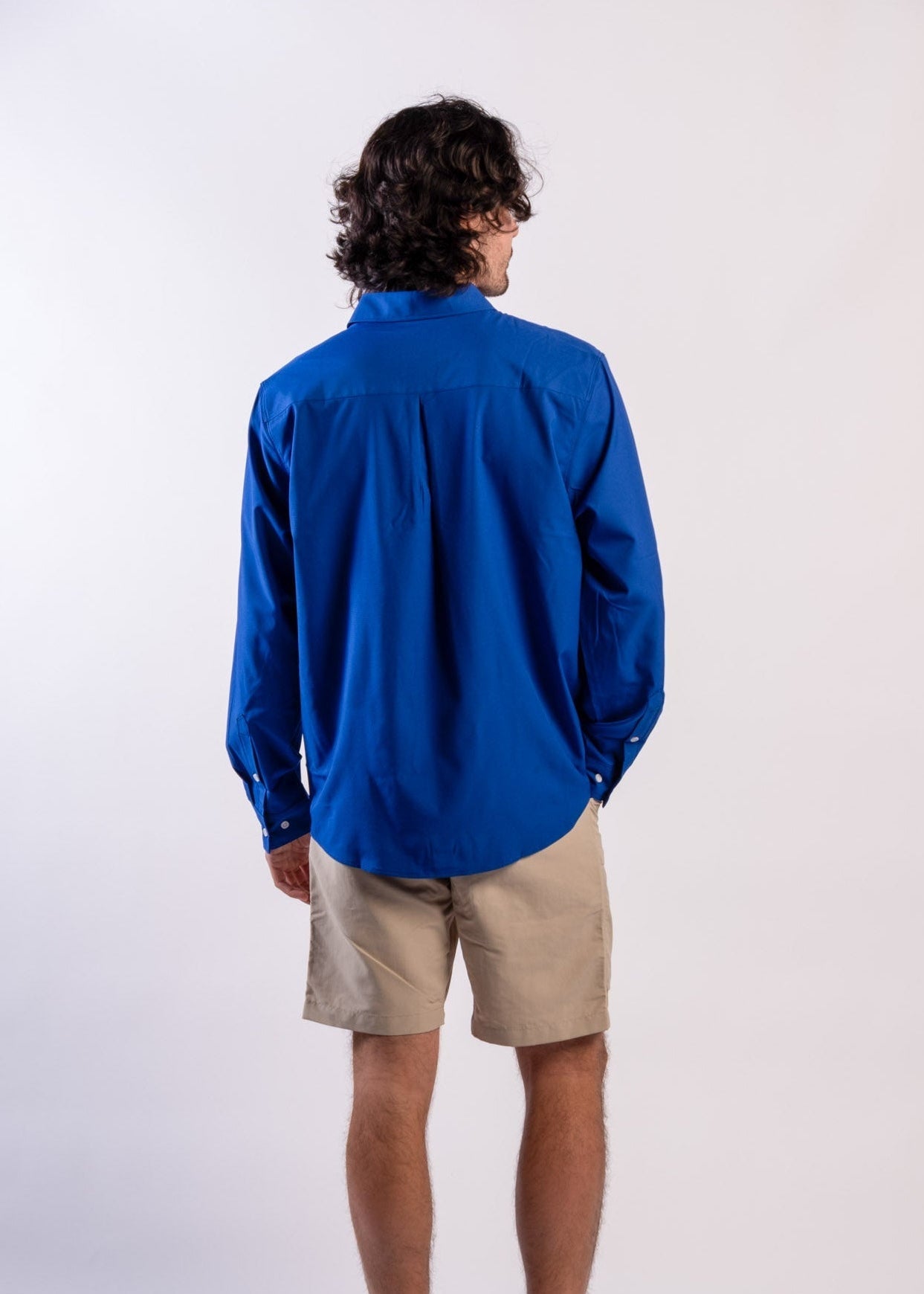 Person wearing a blue UPF50+ Sun protection sun shirt on a white background